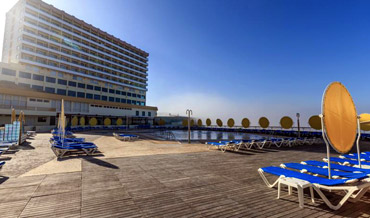 Sun deck with swimming pool and Hotel Golf Mar in Porto Novo